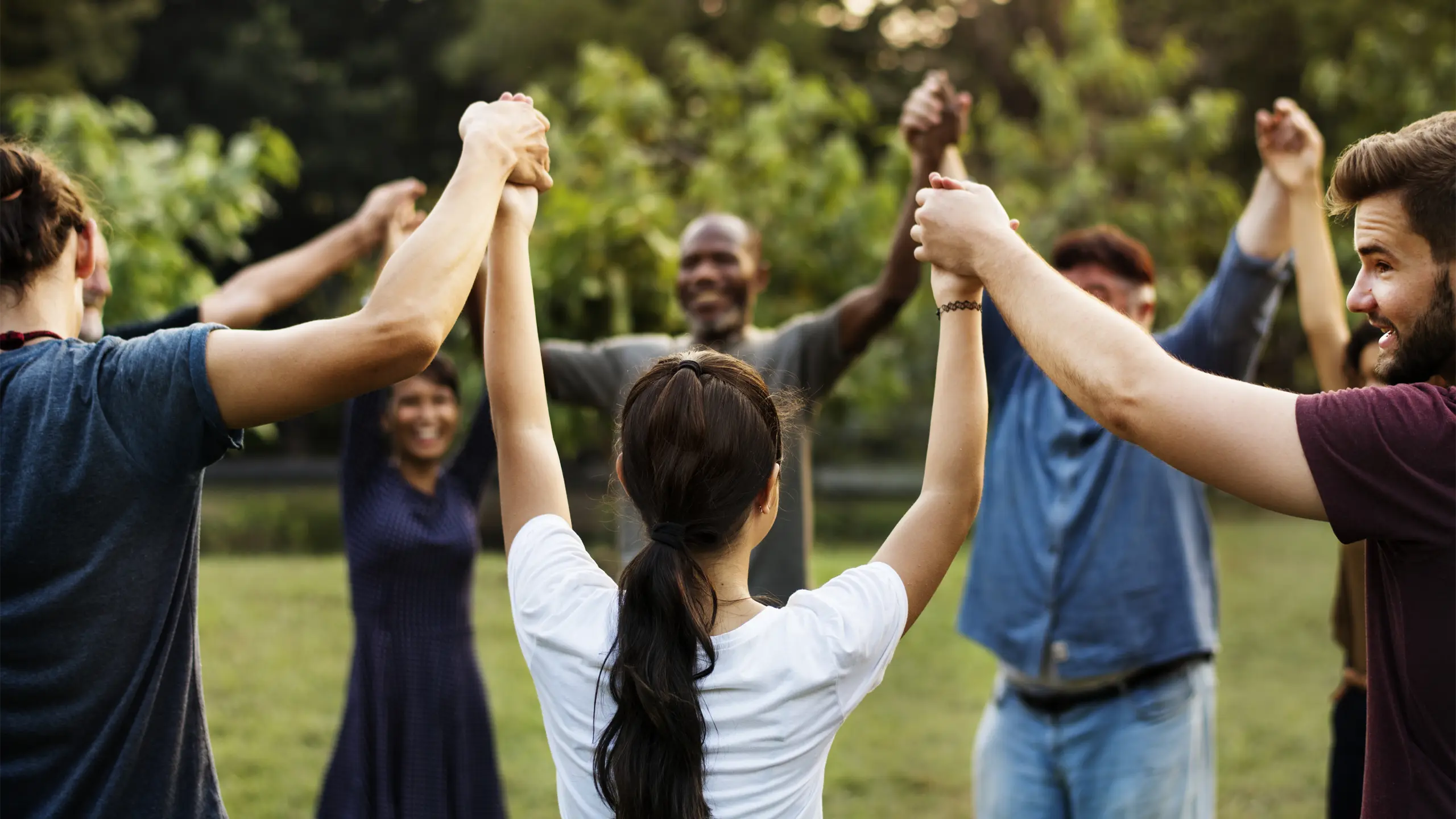 group-people-holding-hand-together-park