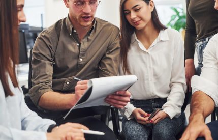 Young business people working with documents together in the modern office.